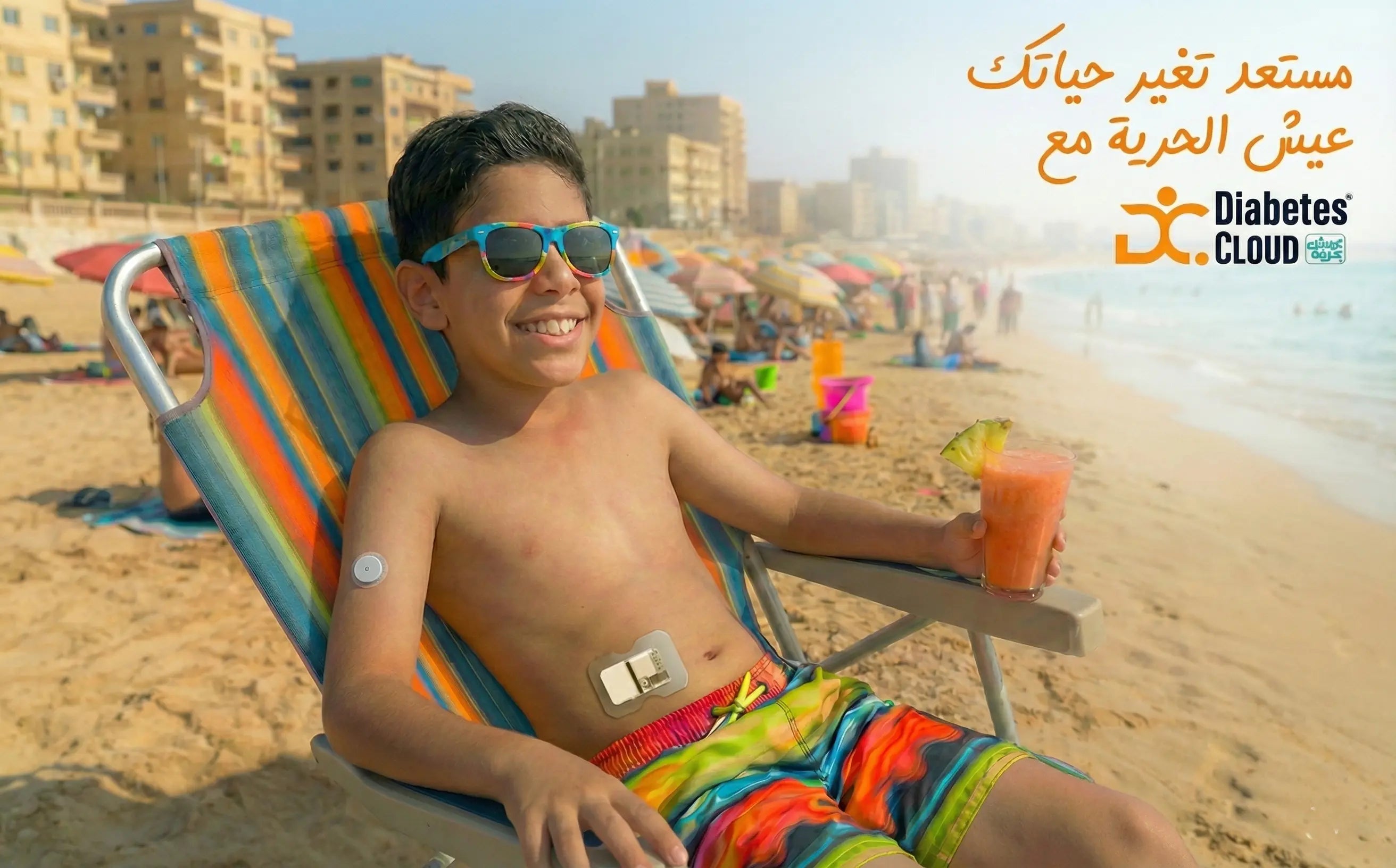 Boy_with_diabetes_monitor_and_insukin_pumb_with_drink_on_sunny_beach_chair_Diabetes_Cloud_logo_and_text